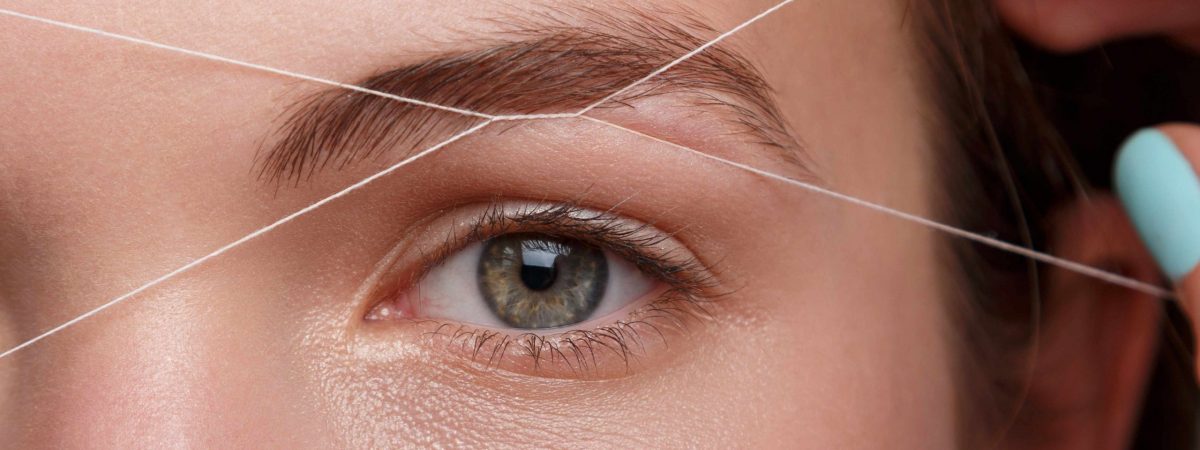 Close-up of female face during eyebrow correction procedure