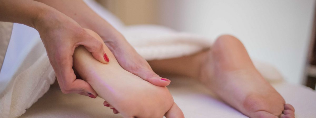 woman-getting-massage-of-feet_red